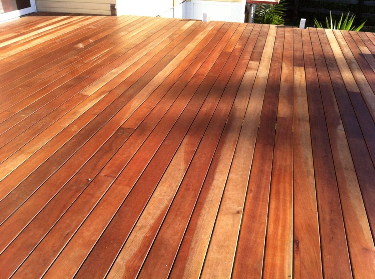 A wooden deck with a smooth, well-constructed wooden floor, emphasizing rustic elegance and durability.